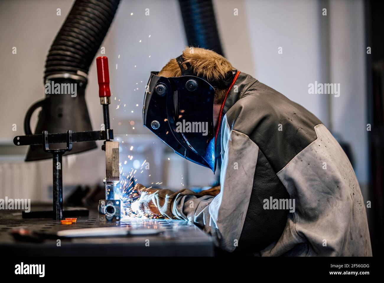 Welder with coveralls working at factory Stock Photo