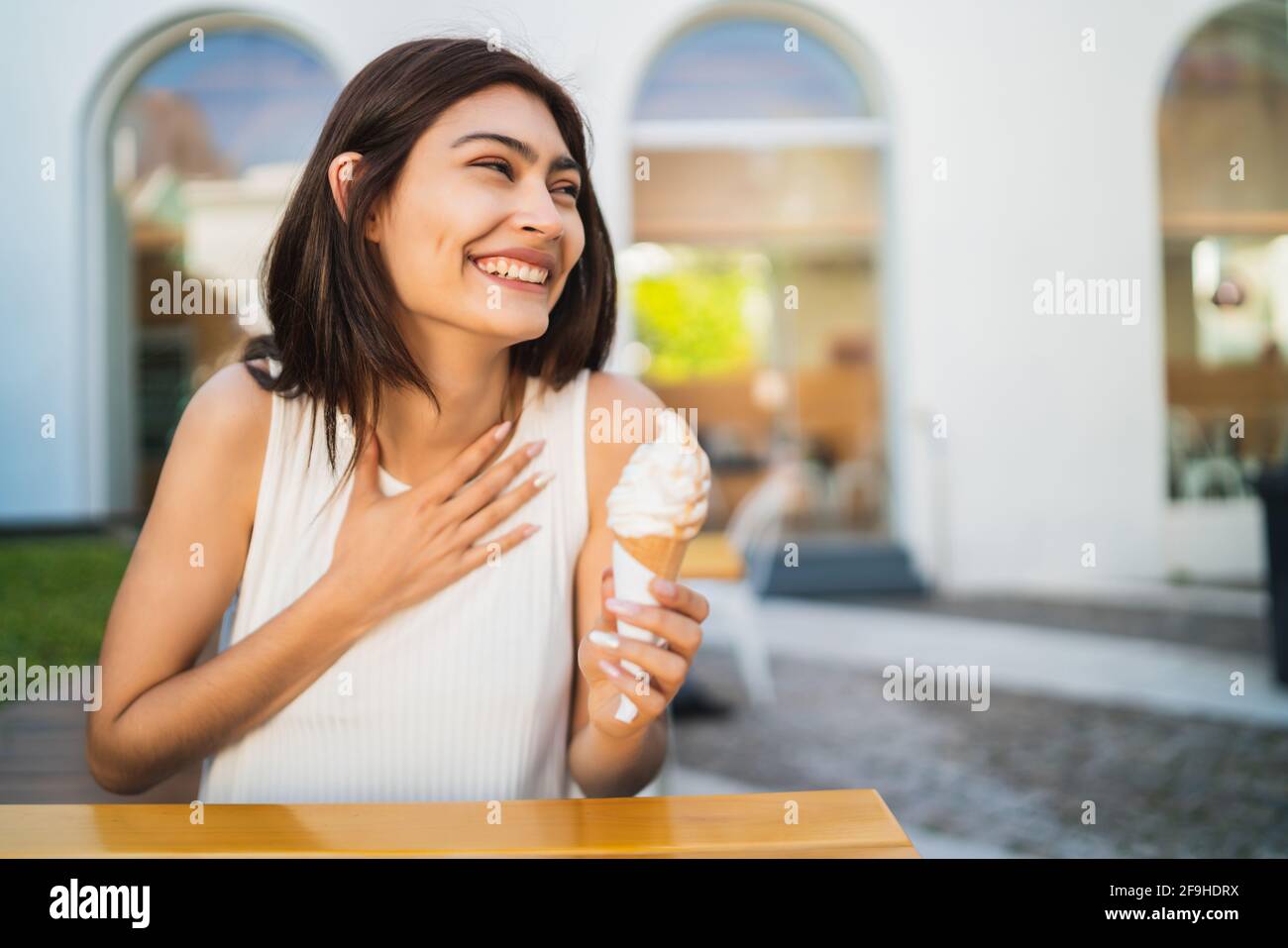 Woman enjoying and eating an ice cream. Stock Photo