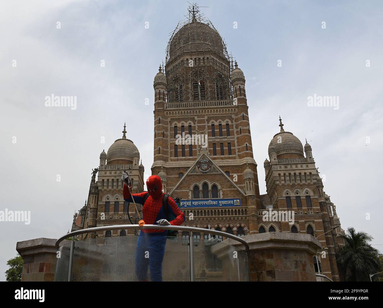 Mumbai, India. 21st Apr, 2021. A man dressed as Spider Man sanitizes outside Brihanmumbai Municipal Corrporation (BMC) building, as a precaution against the spread of coronavirus. Credit: SOPA Images Limited/Alamy Live News Stock Photo