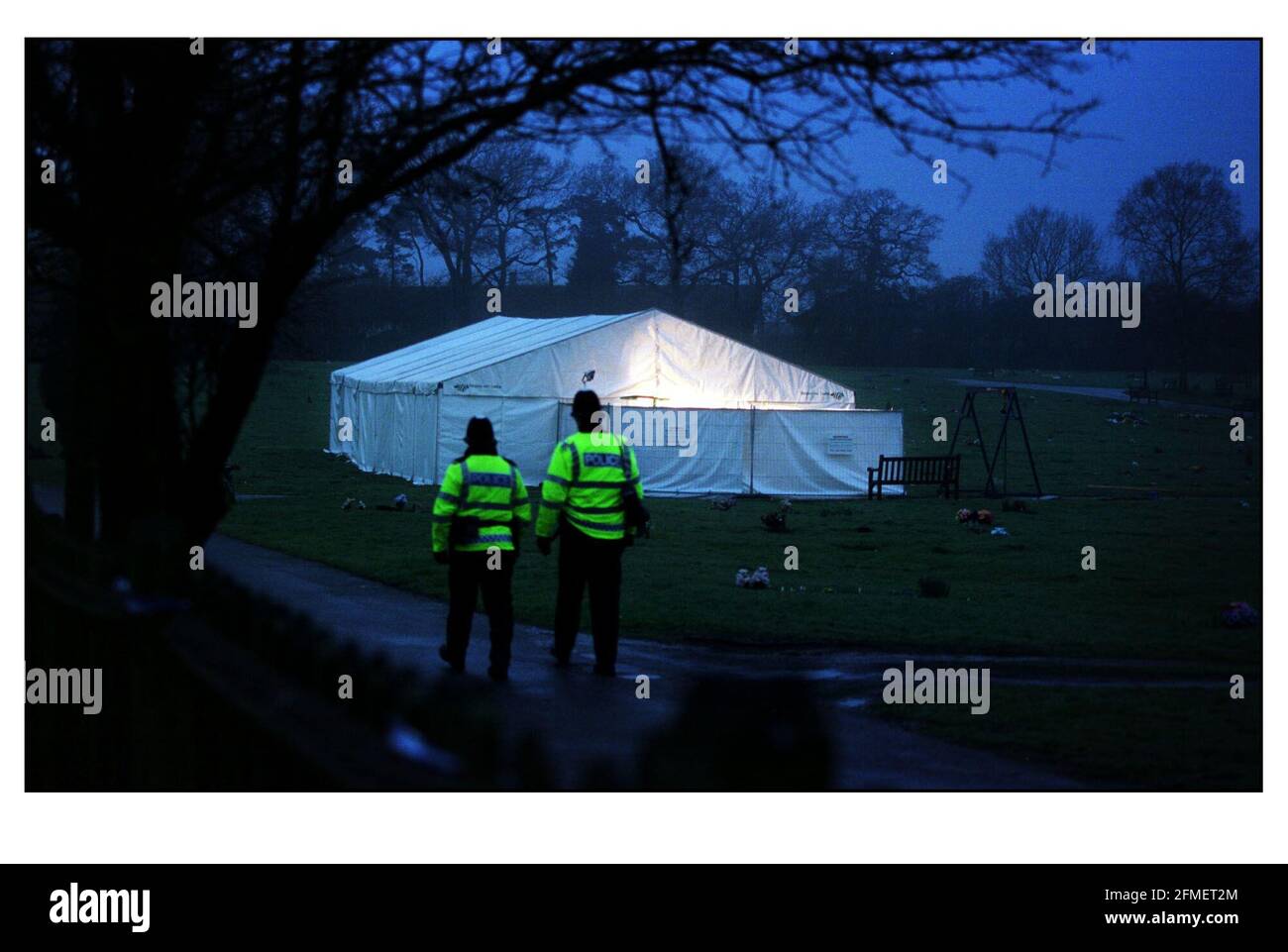 Two policemen patrol the cold damp cemetry in Carpenders park, Hertfordshire where James Hanratty's body was being  exhumed by Police for DNA samples. Stock Photo