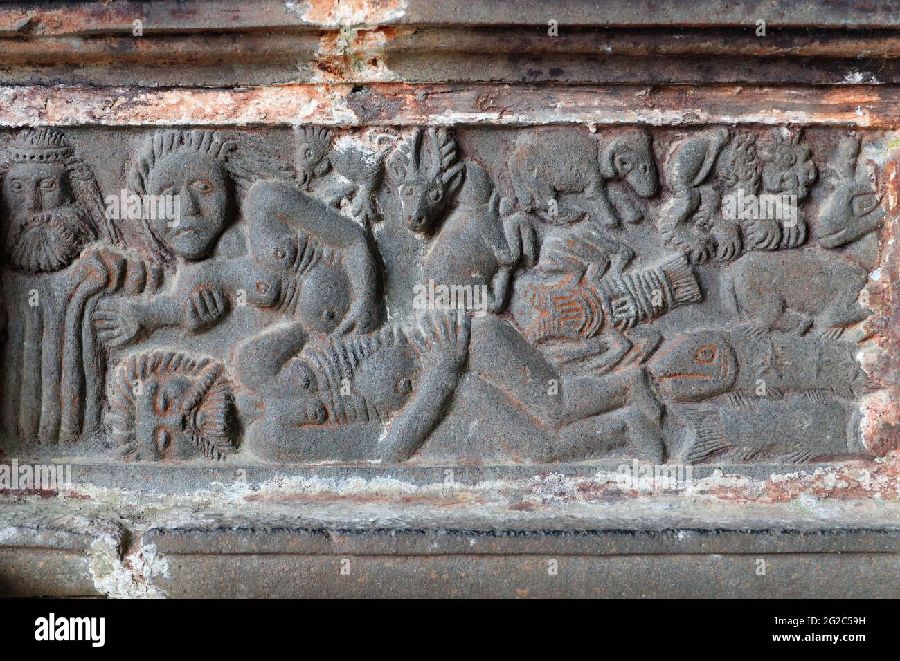 Creation of Eve - God helps withdraw Eve from Adam's rib by pulling on her arms. The frieze inside the south porch of church Saint-Miliau. Stock Photo