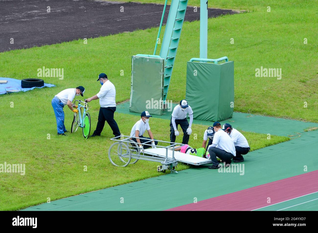 A female competitor lies injured after an accident in a 'keirin' cycle race at Kyoto Keirin Racetrack in Mukomachi, Kyoto, Japan. Stock Photo