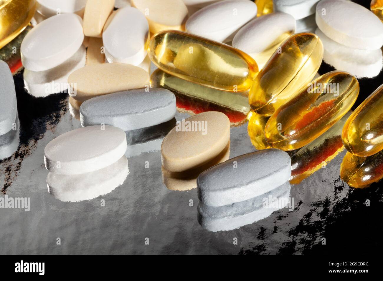 vitamin pills on reflective background Stock Photo