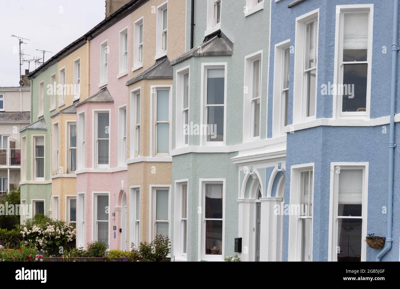 Colourful Victorian terraced houses on the coast in Beaumaris, Anglesey. The victorian terrace is known as Beaumaris West End; Anglesey Wales UK Stock Photo