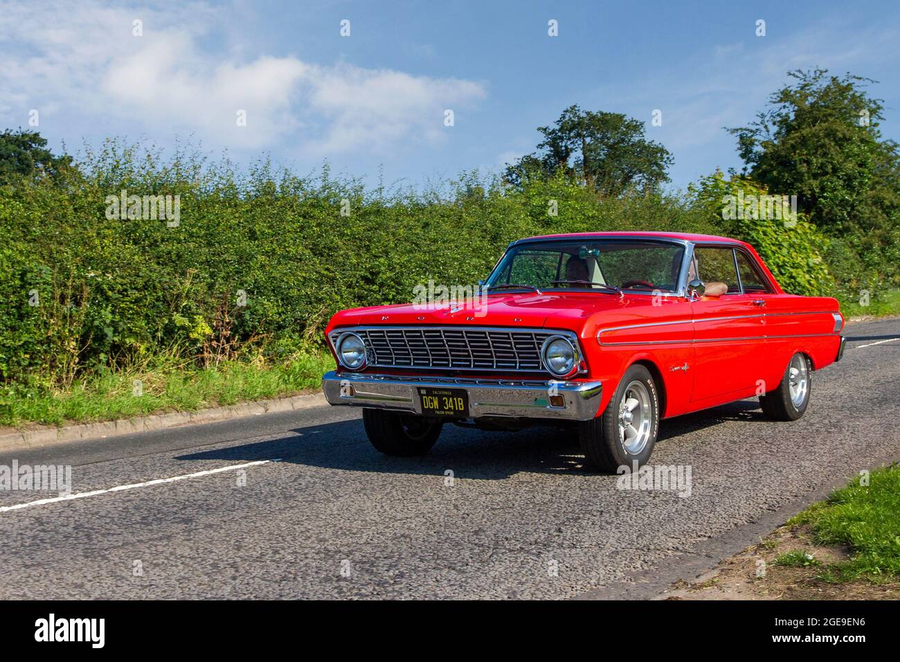 1964 60s sixties red American Ford Falcon Sprint 4230cc petrol pony car en-route to Capesthorne Hall classic July car show, Cheshire, UK Stock Photo