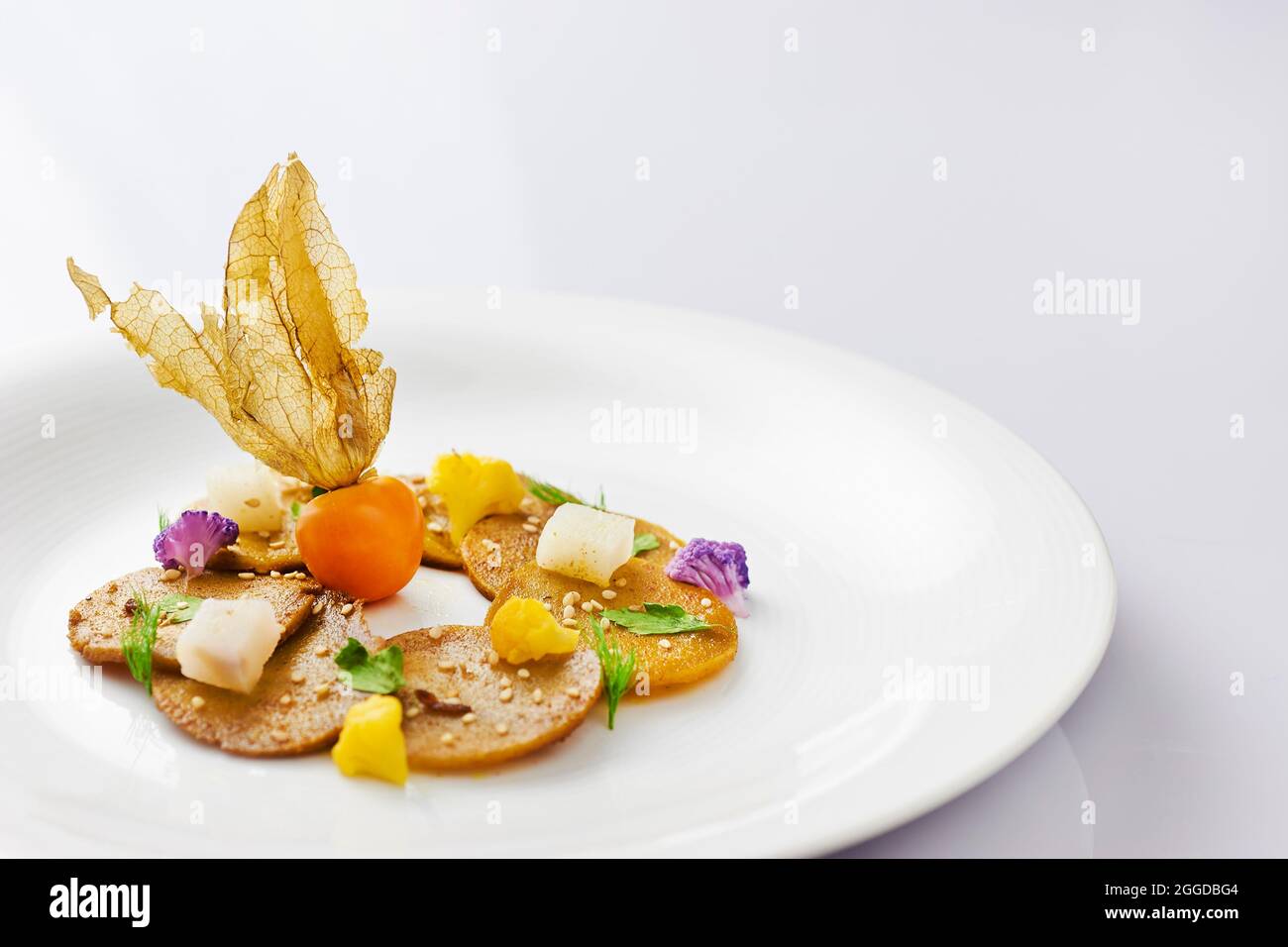 Seitan carpaccio cooked in a pan with curry and deglazed with umeboshi acidulated Stock Photo