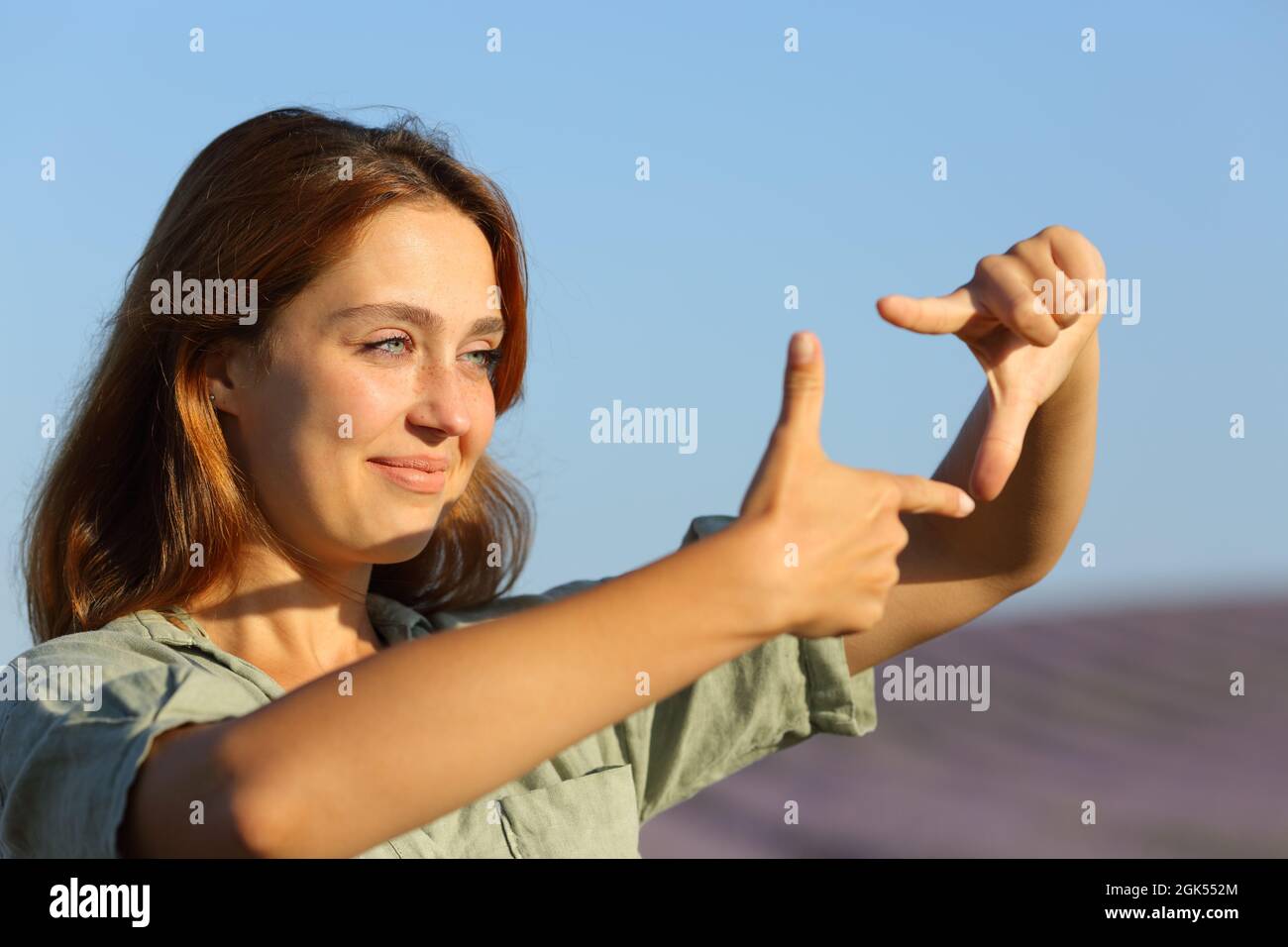 Happy woman framing with her hands in lavender field Stock Photo