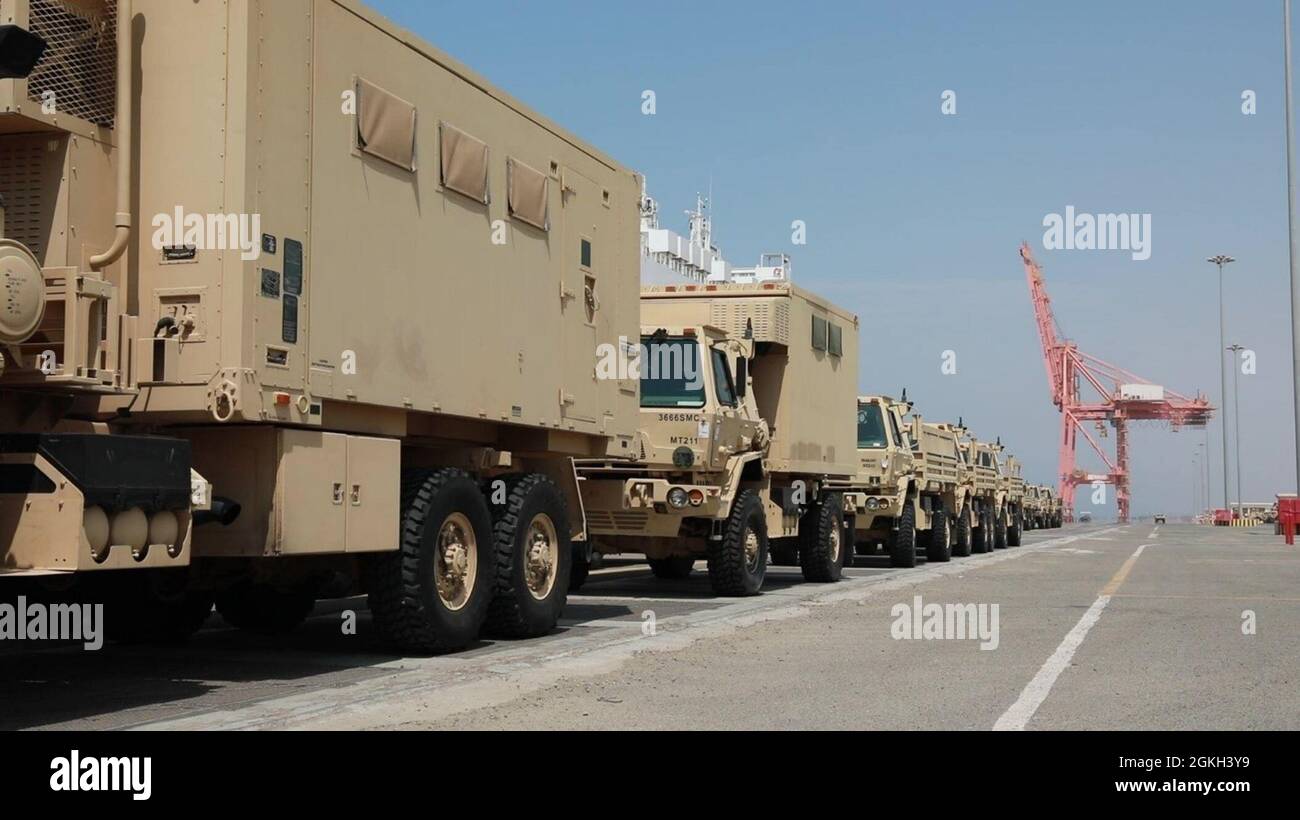 Military vehicles are stationed in a row after offload from the Liberty Peace cargo vessel at the industrial port of Yanbu, Kingdom of Saudi Arabia April 20, 2021. They will be transported back to Kuwait as part of logistics Exercise, LOGEX21. The military vehicles included the M2/A2 Bradley Fighting Vehicle, Light Medium Tactical Vehicles (LMTV), and the High Mobility Multipurpose Wheeled Vehicle (HMMWV). LOGEX 21 demonstrates the 1st Theater Sustainment Command’s readiness and ability to provide responsive support to U.S. and partner nation forces from anywhere in the U.S. Central Command th Stock Photo