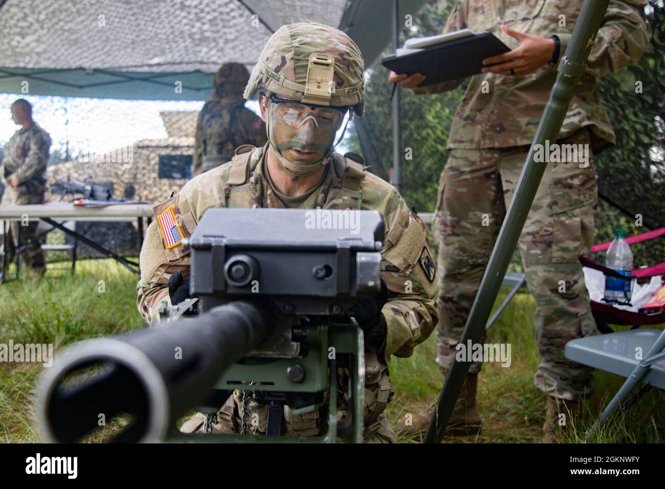 Spc. Austin Falerios, an AH-64 armament/electrical/avionic systems repairer assigned to Bravo Company, 46th Aviation Support Battalion, 16th Combat Aviation Brigade and an Atascadero, Calif., native, performs timed weapon assembly, disassembly, and functions check during the I Corps Best Warrior Competition at Joint Base Lewis-McChord, Wash., June 8, 2021. The competition encompassed four days of grueling tasks designed to test their knowledge, physical and mental endurance, and leadership skills. Stock Photo