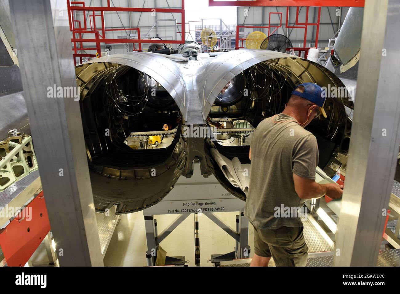 Chet Jones, 561st Aircraft Maintenance Squadron sheet metal mechanic, fits a part for an F-15 Eagle aircraft tail cone at the Warner Robins Air Logistics Complex at Robins Air Force Base, Georgia, June 8, 2021. The 561st AMXS accomplishes inspection, modification, maintenance and repair on F-15 aircraft. Stock Photo