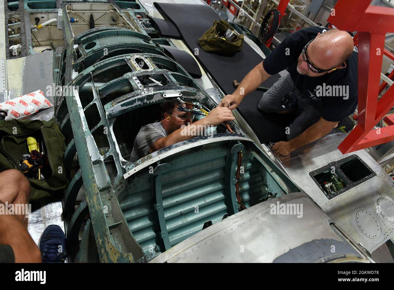 Jason Nasworthy, left, and Jamie Shipes, 561st Aircraft Maintenance Squadron sheet metal mechanics, work to replace Longerons on an F-15 aircraft at the Warner Robins Air Logistics Complex at Robins Air Force Base, Georgia, June 8, 2021. The 561st AMXS accomplishes inspection, modification, maintenance and repair on F-15 aircraft. Stock Photo