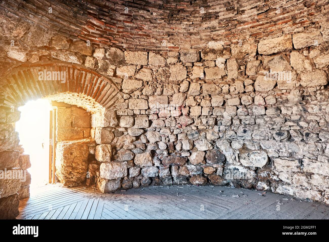 Interior of Sigacik castle battlement in Turkey with stone walls and door. Historical Seljukian architecture. Stock Photo