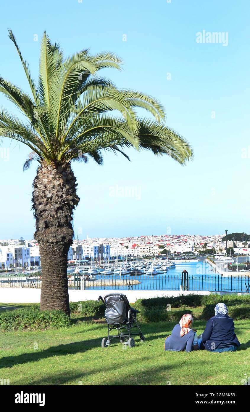 Moroccon woman sitting in a park and enjoying the views of the bou regreg river and Salé, Morocco. Stock Photo