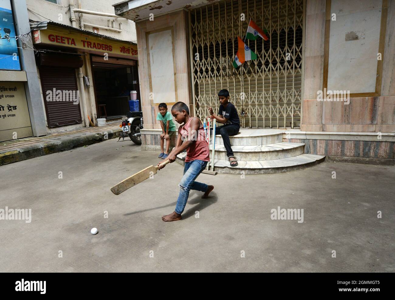 Marathi boys playing cricket by their home in Pune, India. Stock Photo