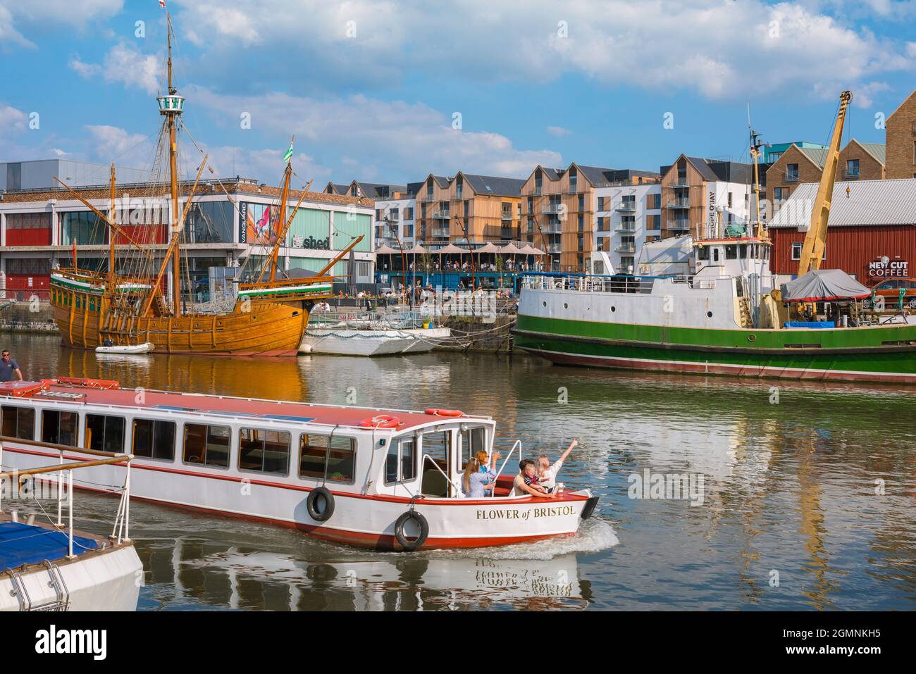 Bristol tourism, view in summer of people enjoying a tour by boat of the historic Bristol Harbourside area, England, UK Stock Photo