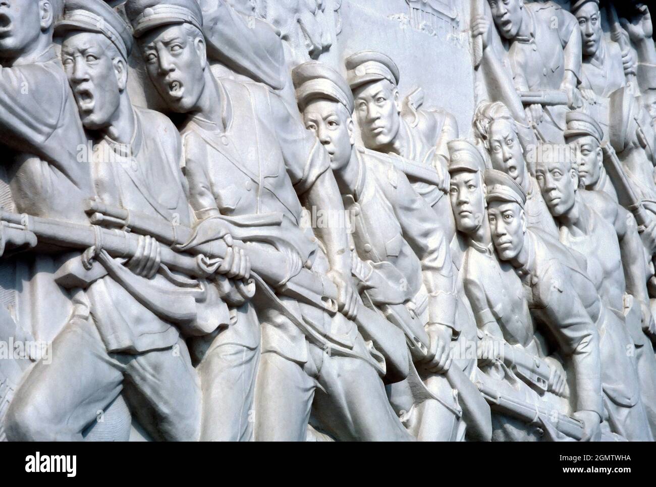 Beijing, China - 1982; Art or Propaganda? Raging 'Socialist Realism' carvings on the side of Mao's Mausoleum in Tienanmen Square, Beijing China. Stock Photo