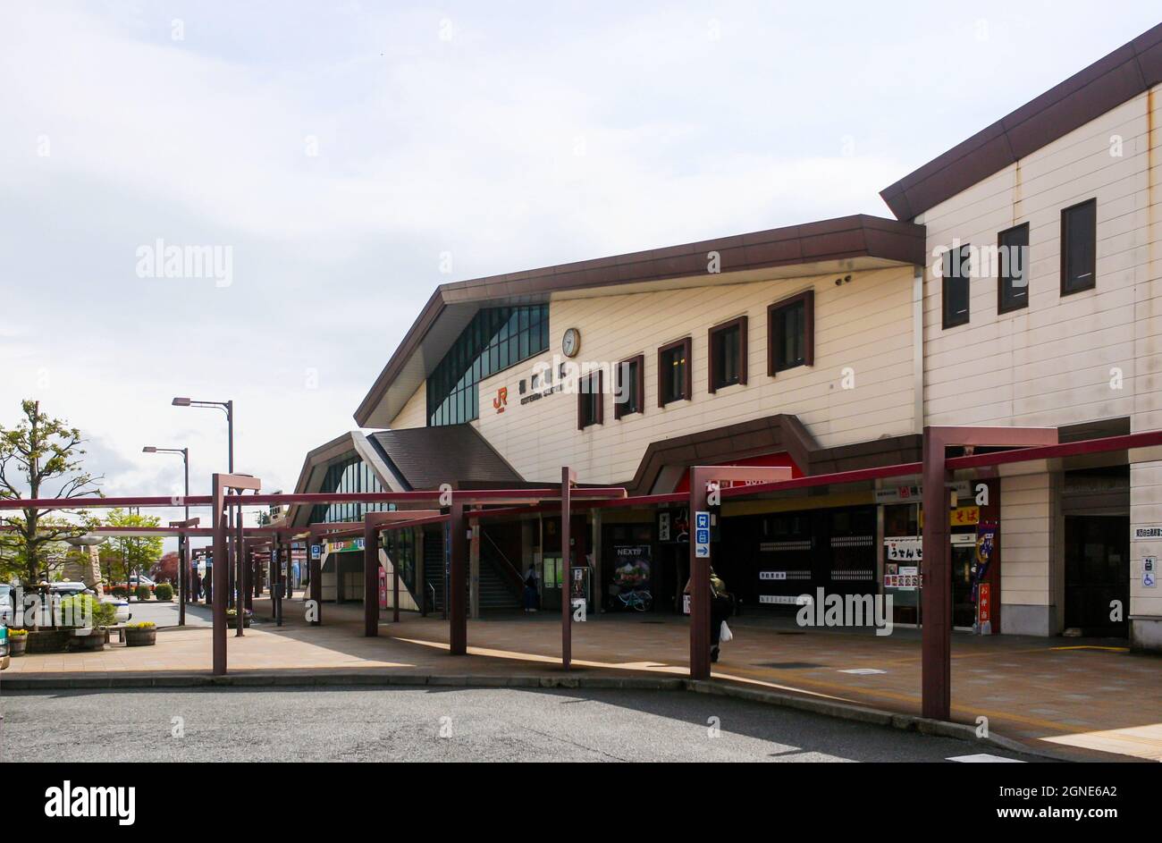 View of front exterior of Gotemba Station in Shizuoka Prefecture with clouds in blue sky background. No people. Stock Photo