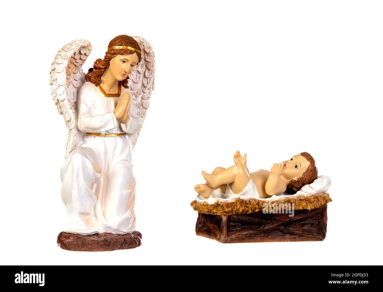 Ceramic figure of The Baby Jesus and the angel of the nativity scene isolated on a white background Stock Photo