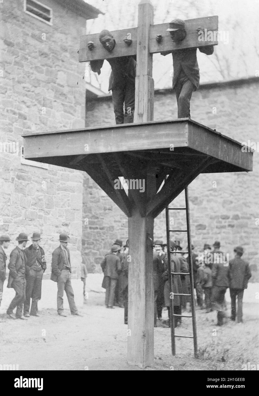 Two prisoners in pillory with another tied to whipping post, America Stock Photo