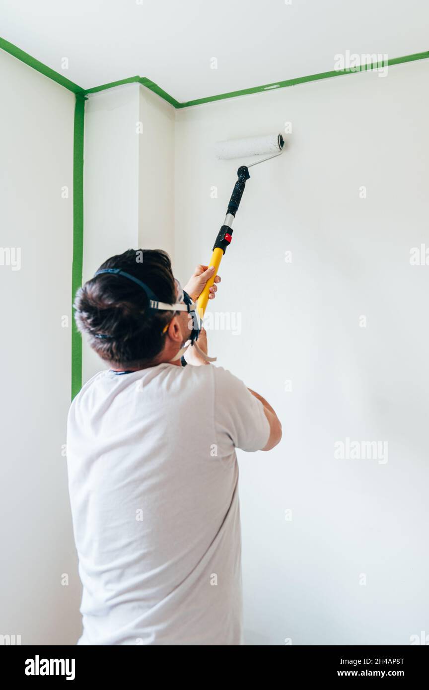 Man is painting wall Stock Photo - Alamy