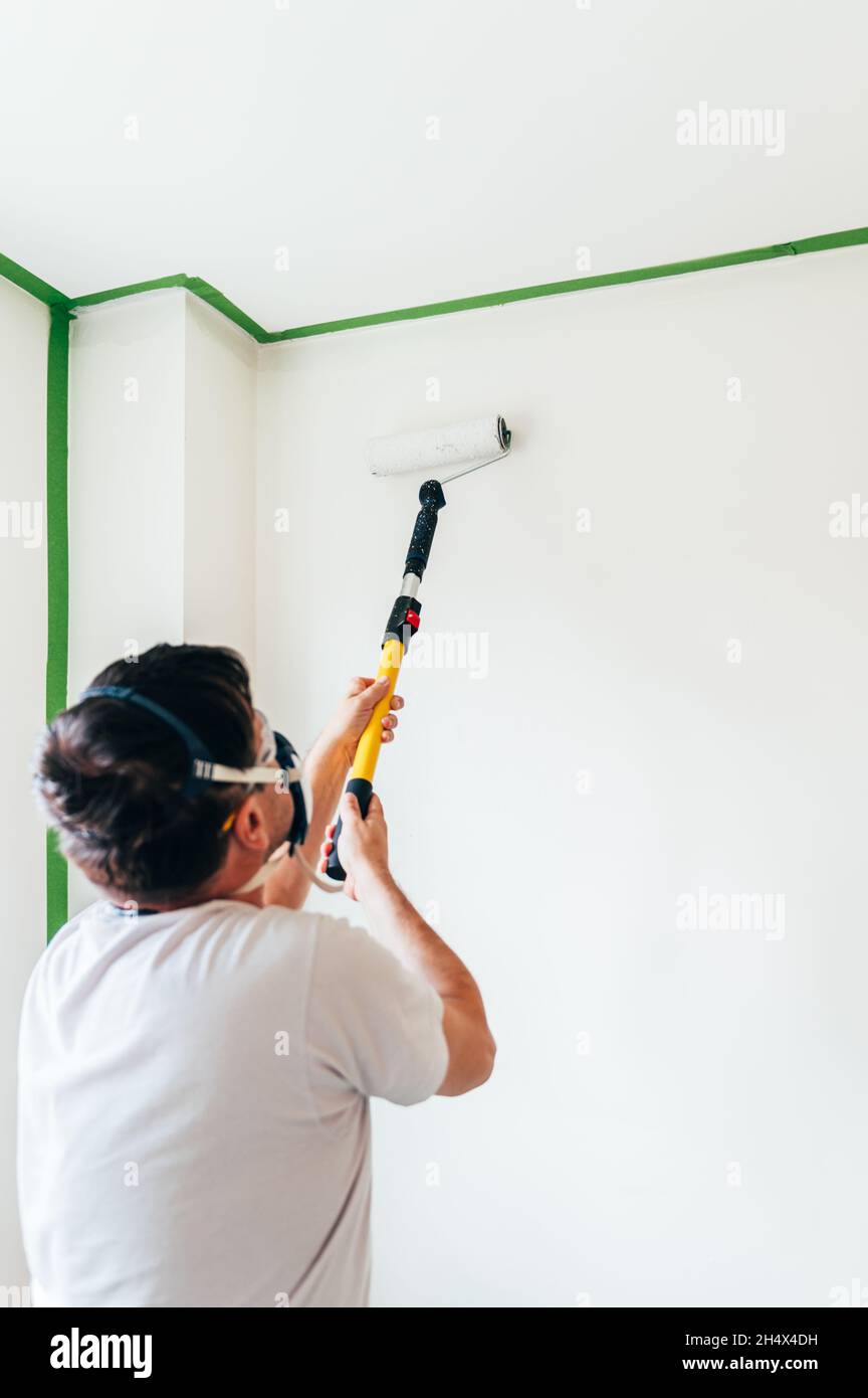 Man is painting wall Stock Photo - Alamy