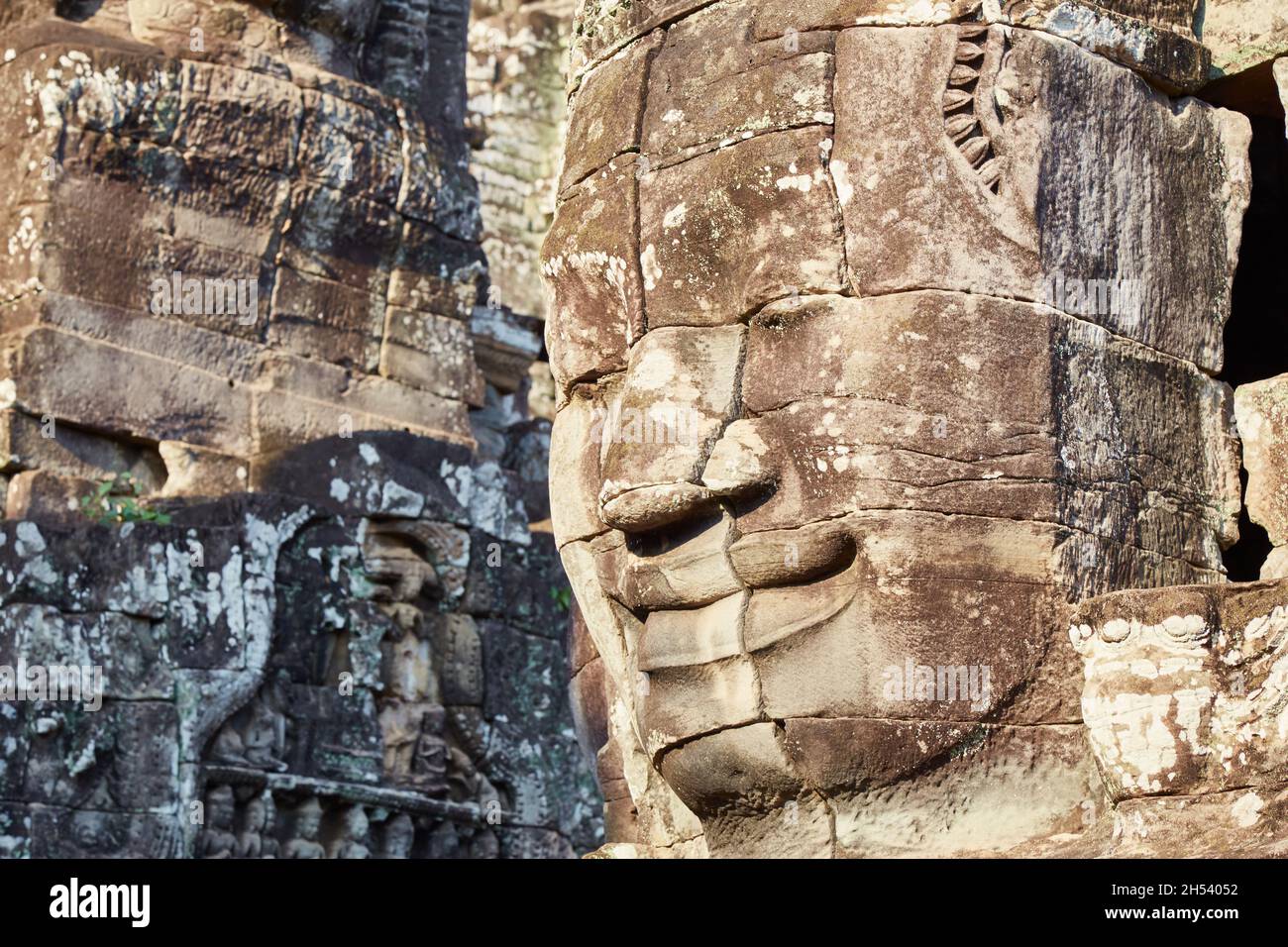 The defining characteristic of the Bayon is its monumental smiling faces, which could either represent Avalokiteshvara or King Jayavarman VII himself Stock Photo