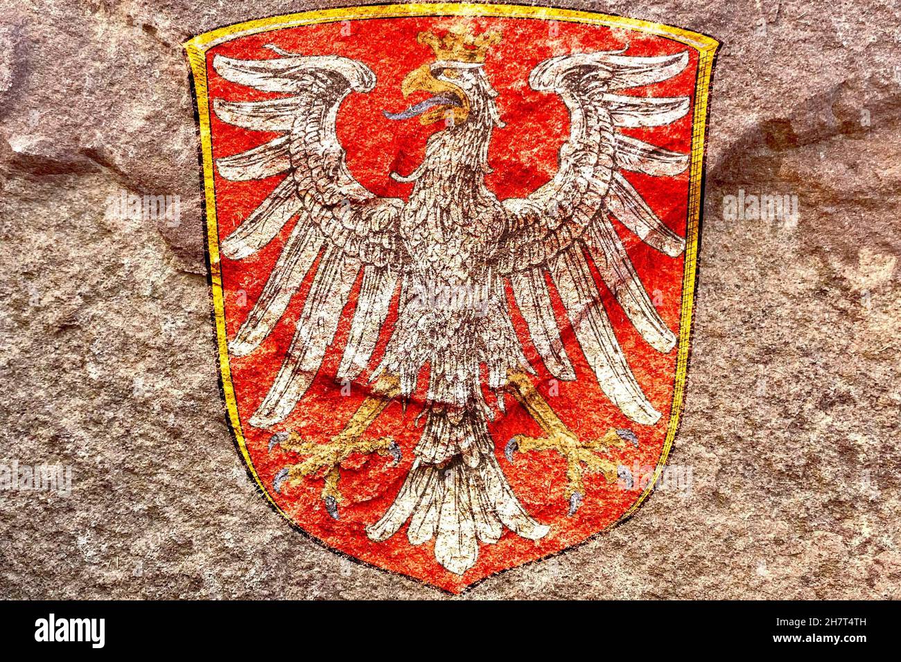 Faded Coat of arms of Frankfurt isolated on weathered solid rock wall background Stock Photo