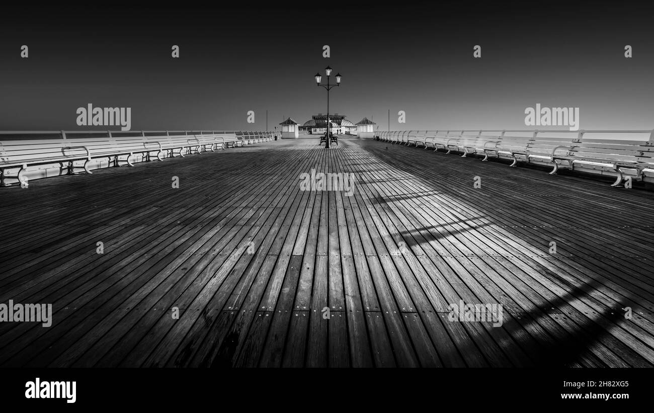 View along Cromer pier at sunrise. Stock Photo