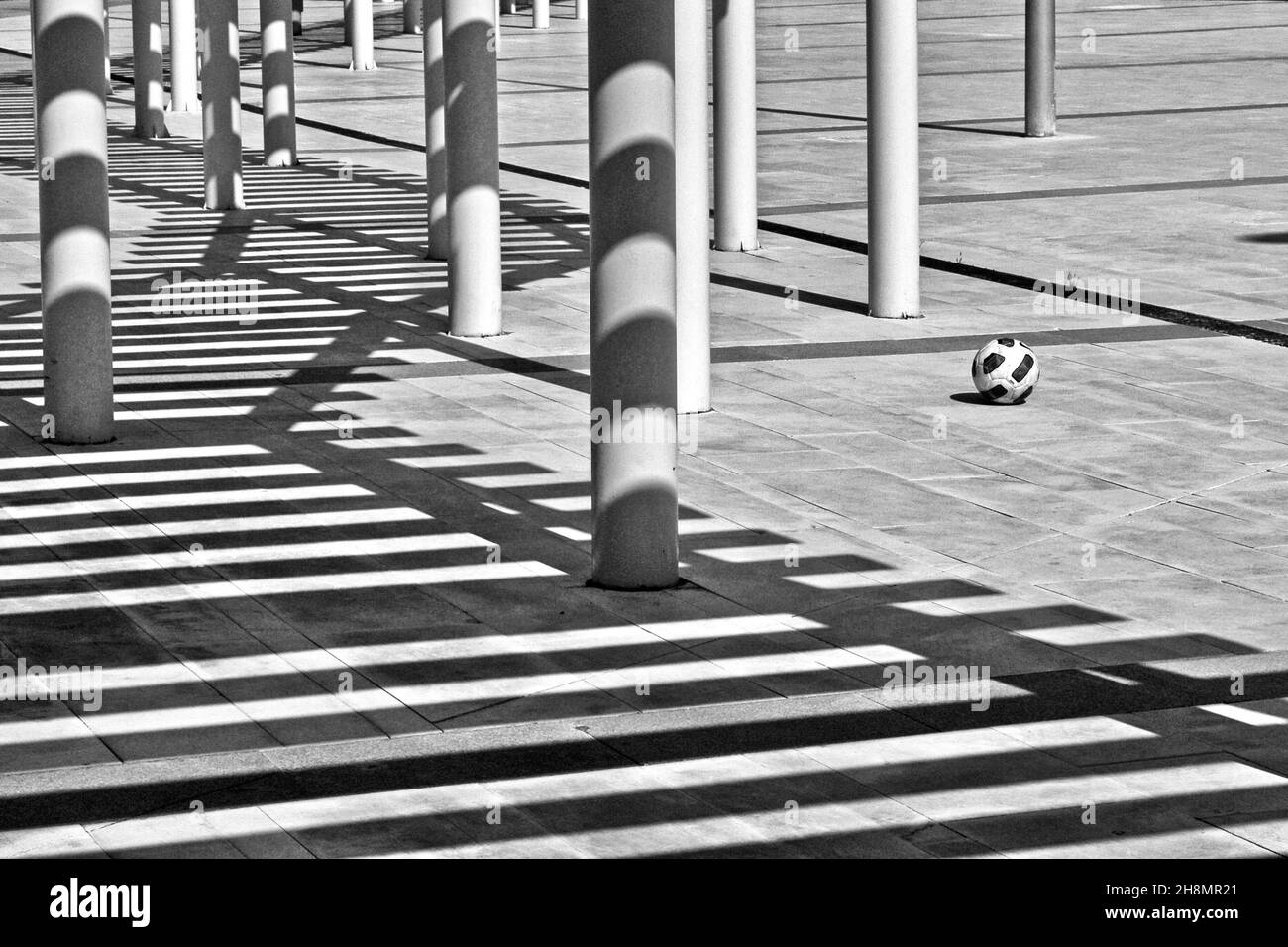 Columns and shadows with single football, Almeria Airport, Almeria, Andalusia, Spain Stock Photo