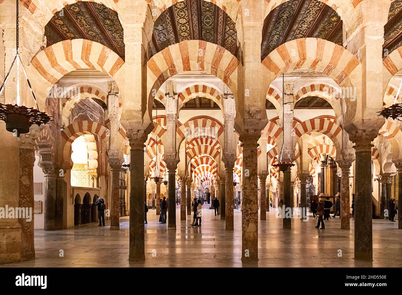 CORDOBA ANDALUCIA SPAIN INTERIOR MOSQUE - CATHEDRAL OR MEZQUITA  PEOPLE INSIDE THE VAST HYPOSTYLE PRAYER HALL Stock Photo