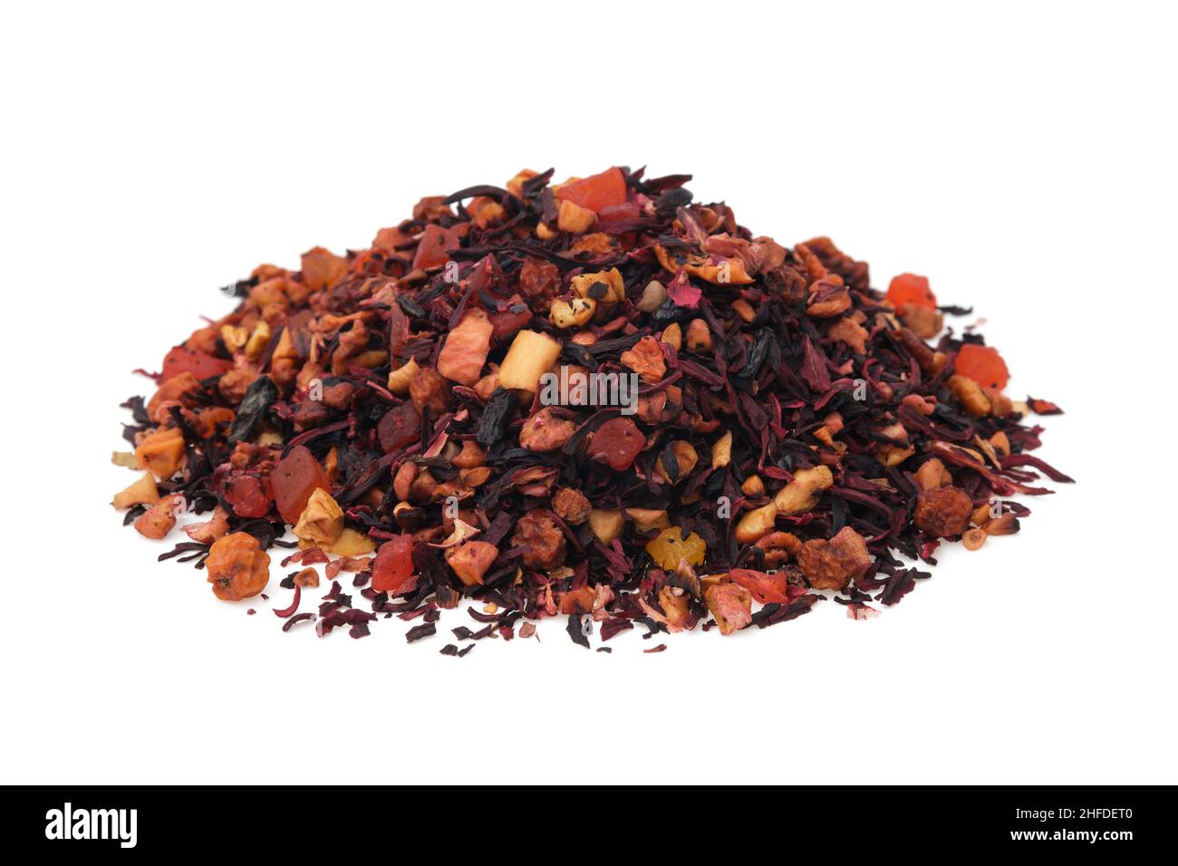 Pile of natural fruit tea with hibiscus petals, fruit slices and berries. Heap of aromatic fruit tea on white. Stock Photo