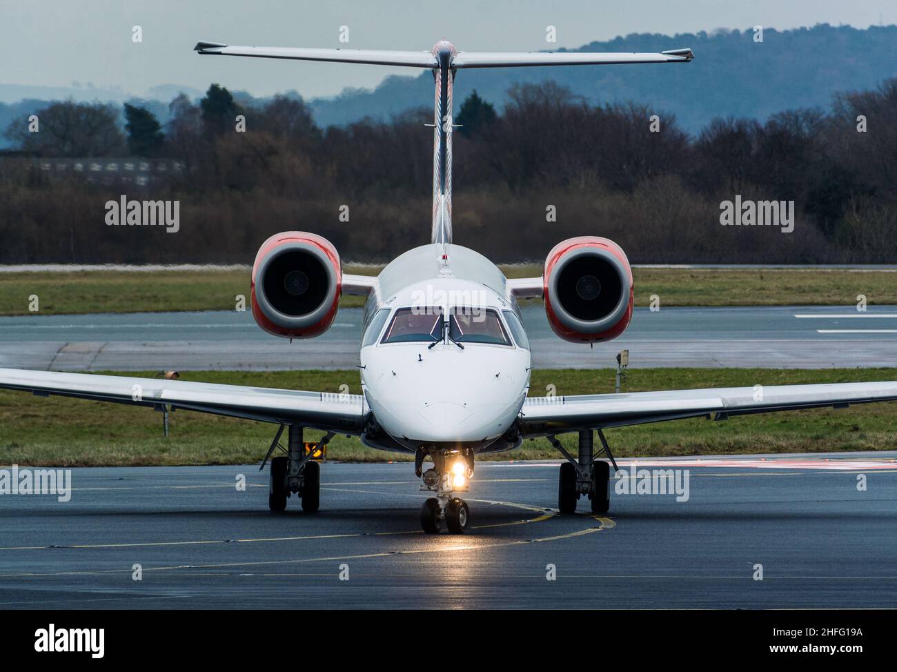 A Loganair Embraer 145 taxiing to the gate at Manchester Airport. Stock Photo