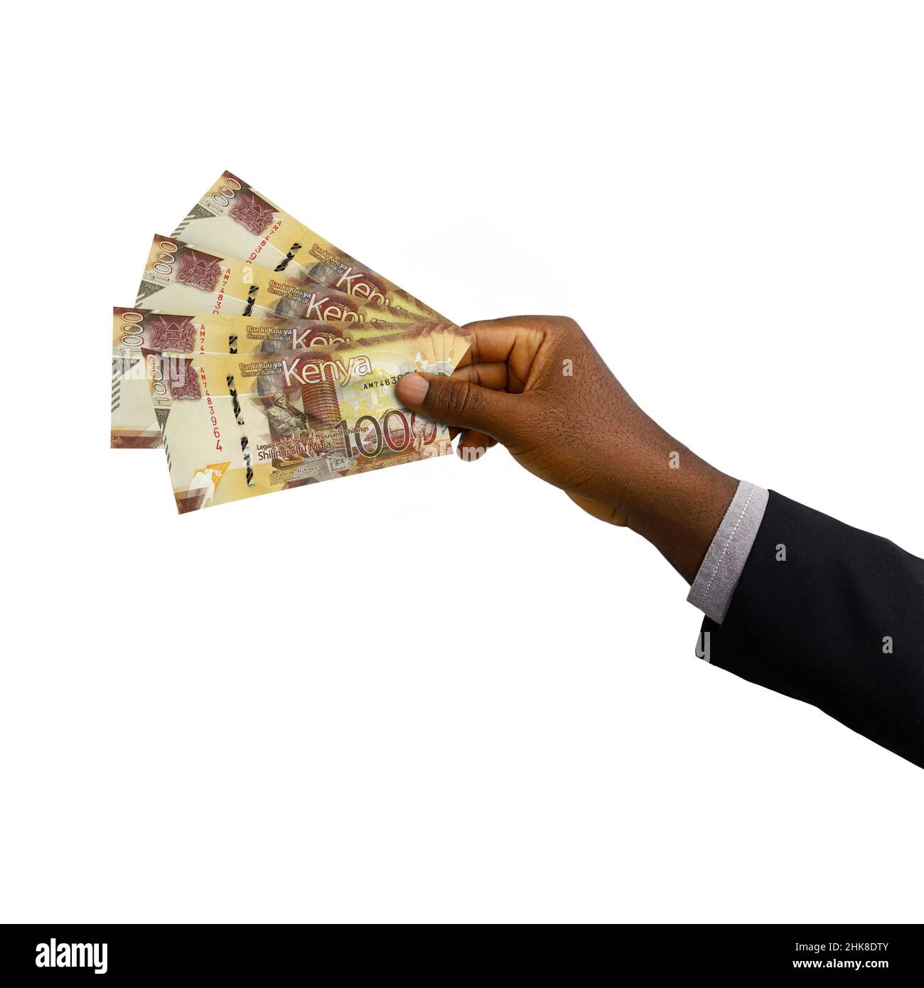 Black hand with suit holding 3D rendered Kenyan Shilling notes isolated on white background Stock Photo