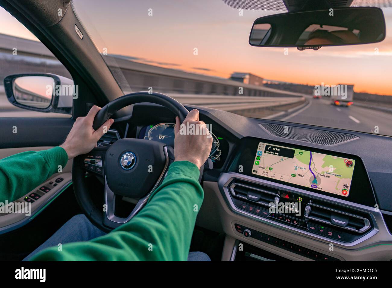 02.09.2022- Hungary: man driving a bmw 3 on the main road with vaze navigation system . Stock Photo