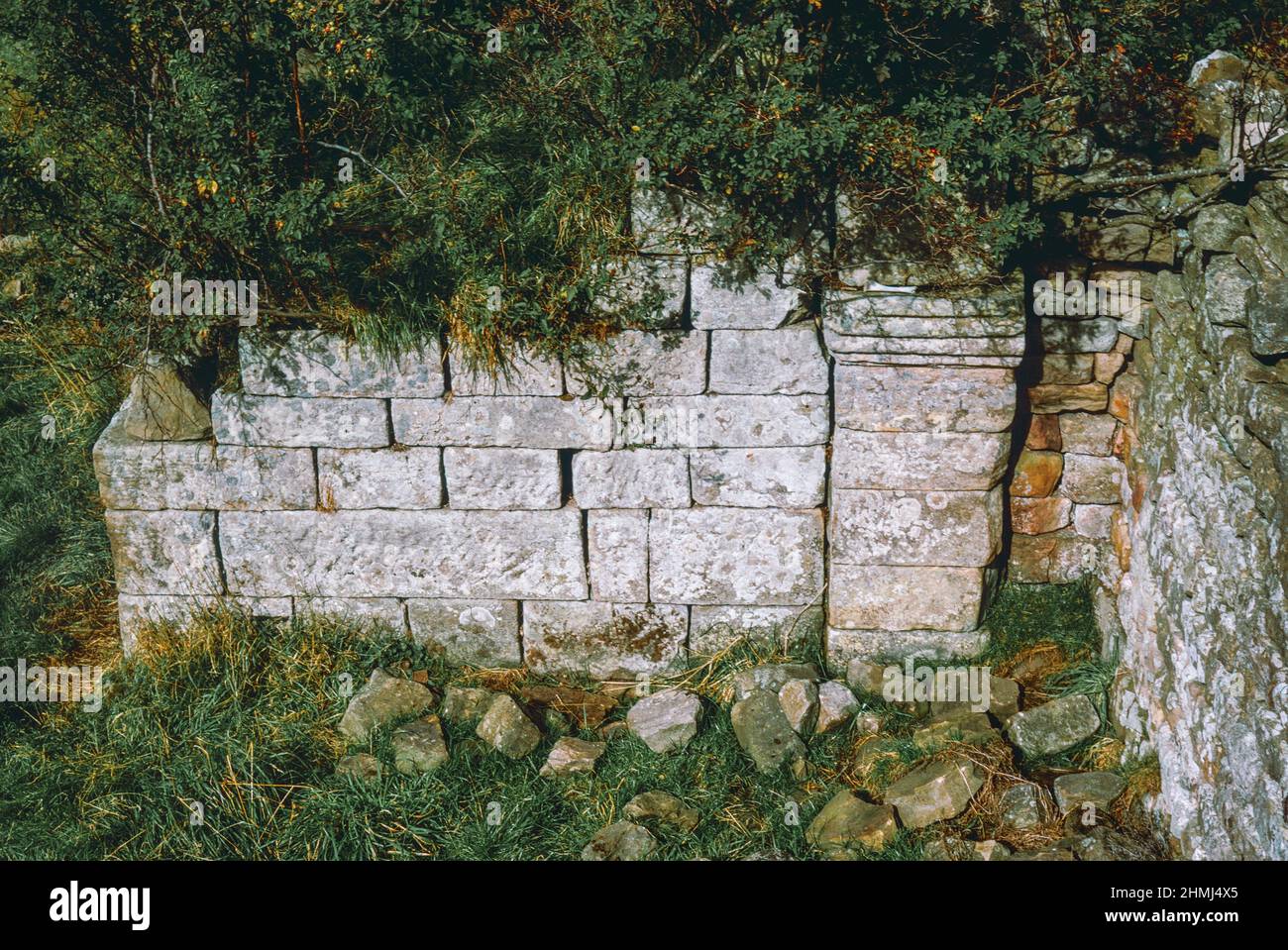 Bremenium - an ancient Roman fort (castrum) located at Rochester, Northumberland, England. The fort was one of the defensive structures built along Dere Street, a Roman road running from York to Corbridge and onwards to Melrose. West gate. Archival scan from a slide. October 1974. Stock Photo