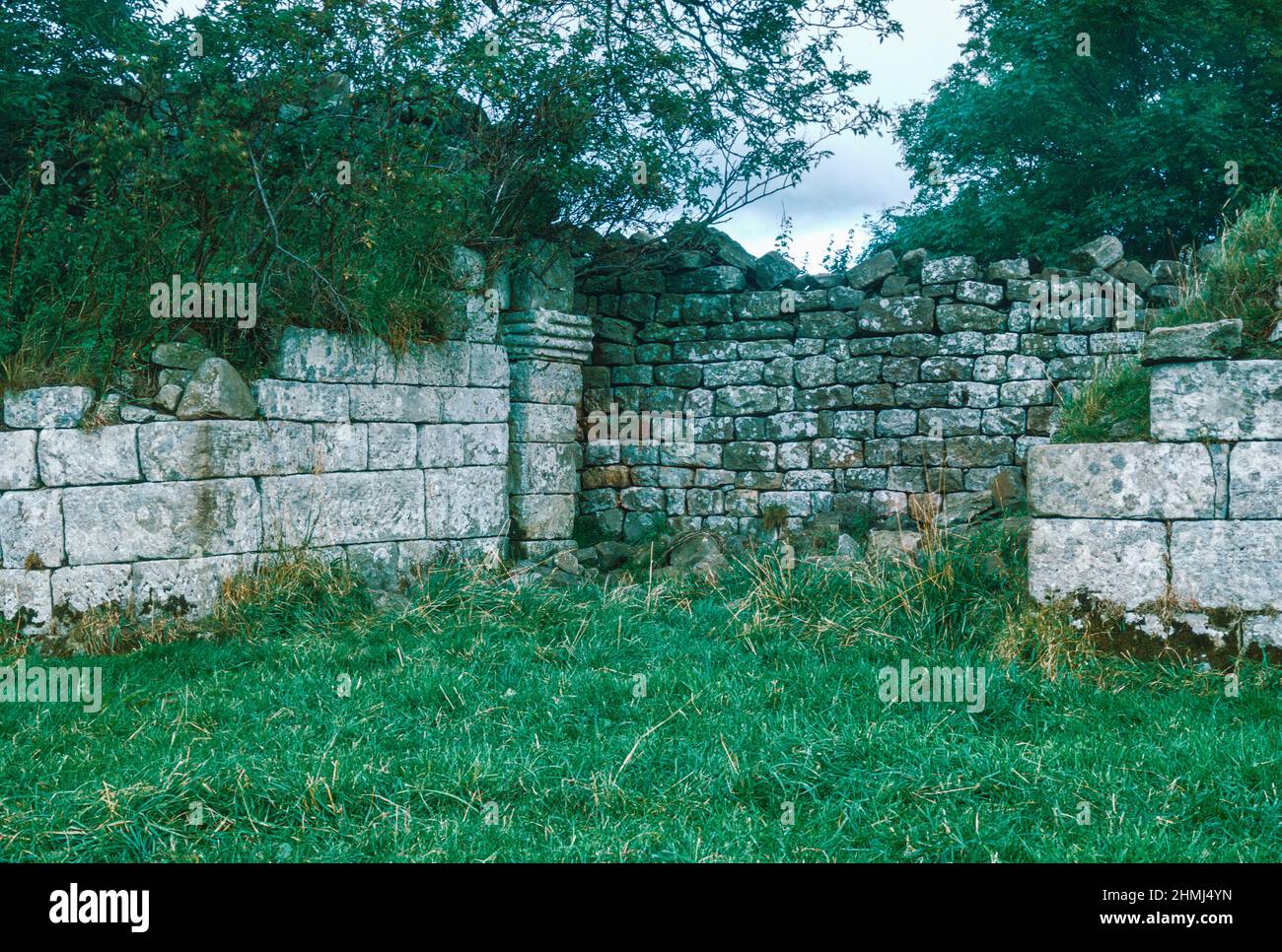 Bremenium - an ancient Roman fort (castrum) located at Rochester, Northumberland, England. The fort was one of the defensive structures built along Dere Street, a Roman road running from York to Corbridge and onwards to Melrose. West walling with a gate. Archival scan from a slide. October 1974. Stock Photo