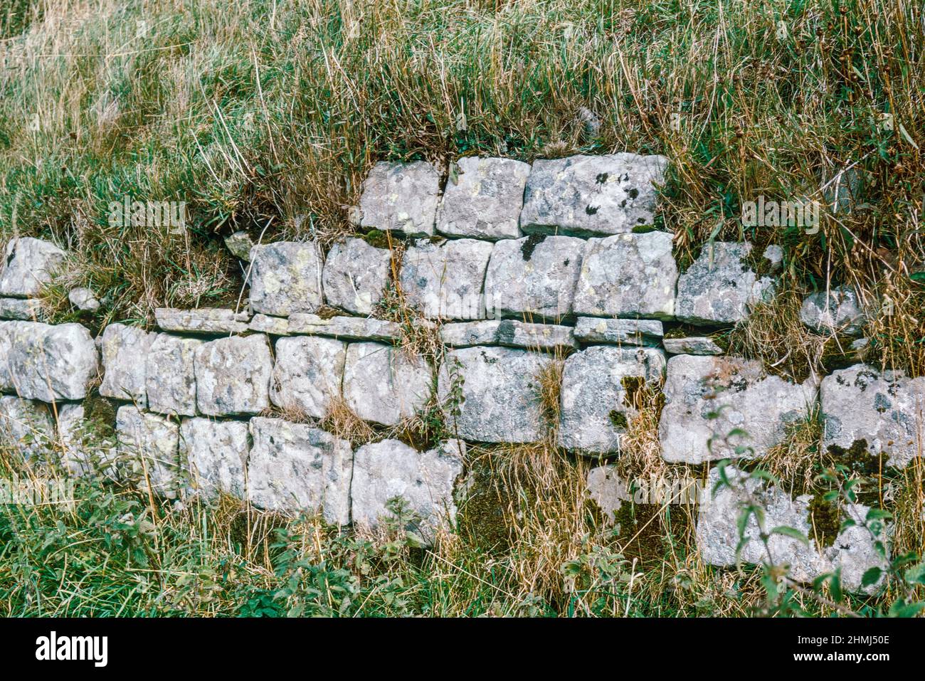 Bremenium - an ancient Roman fort (castrum) located at Rochester, Northumberland, England. The fort was one of the defensive structures built along Dere Street, a Roman road running from York to Corbridge and onwards to Melrose. West walling. Archival scan from a slide. October 1974. Stock Photo