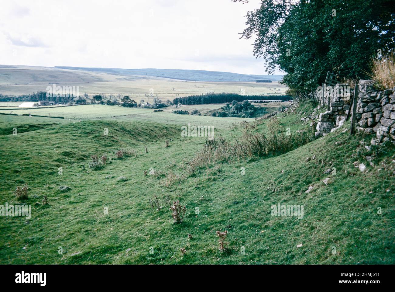 Bremenium - an ancient Roman fort (castrum) located at Rochester, Northumberland, England. The fort was one of the defensive structures built along Dere Street, a Roman road running from York to Corbridge and onwards to Melrose. South wall ditches and interval turret. Archival scan from a slide. October 1974. Stock Photo