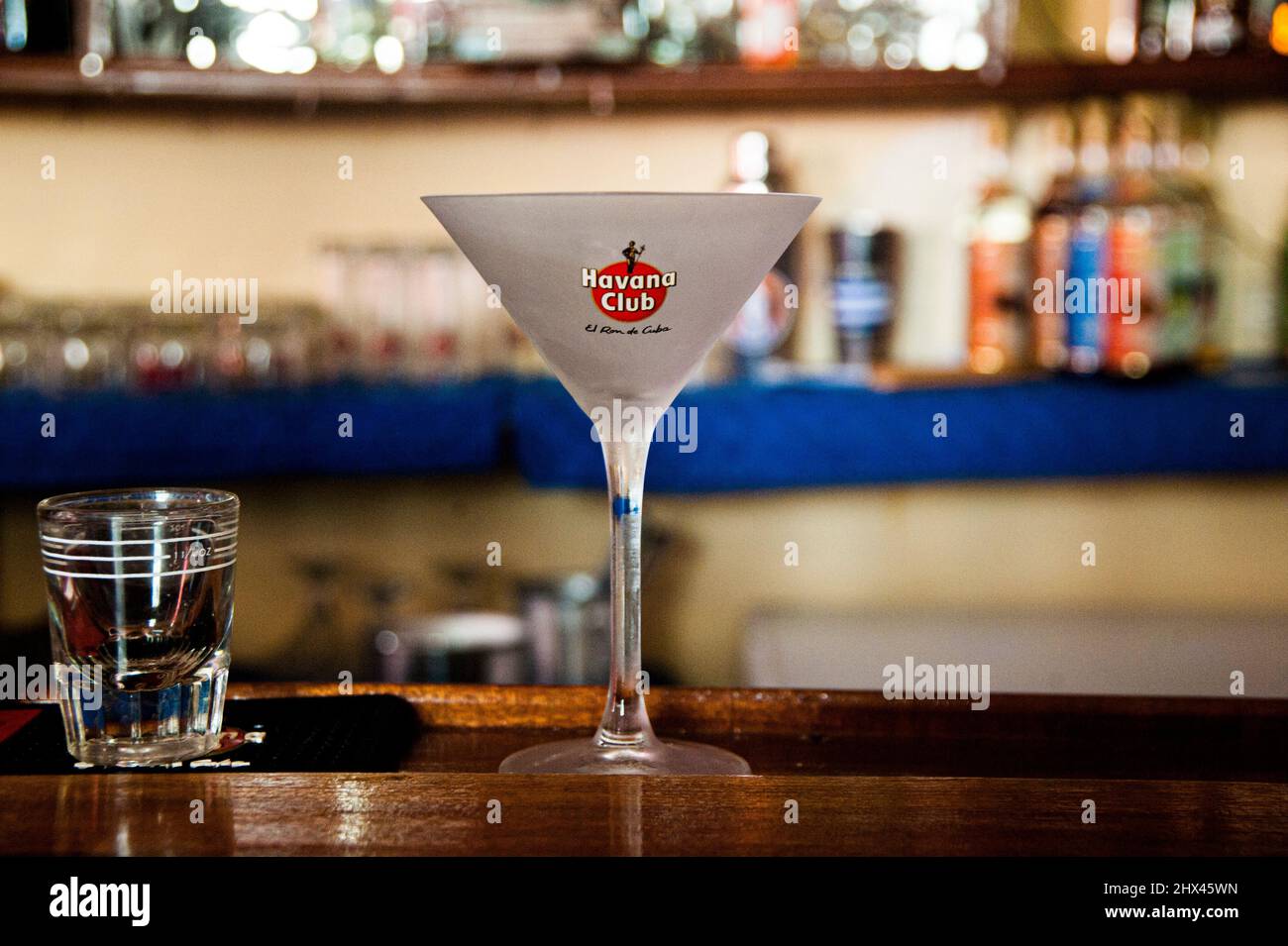 Salud and cheers! Glass of Havana Club rum, the rum of cuba, at a bar in the Unesco heritage town of Havana, Cuba. Stock Photo