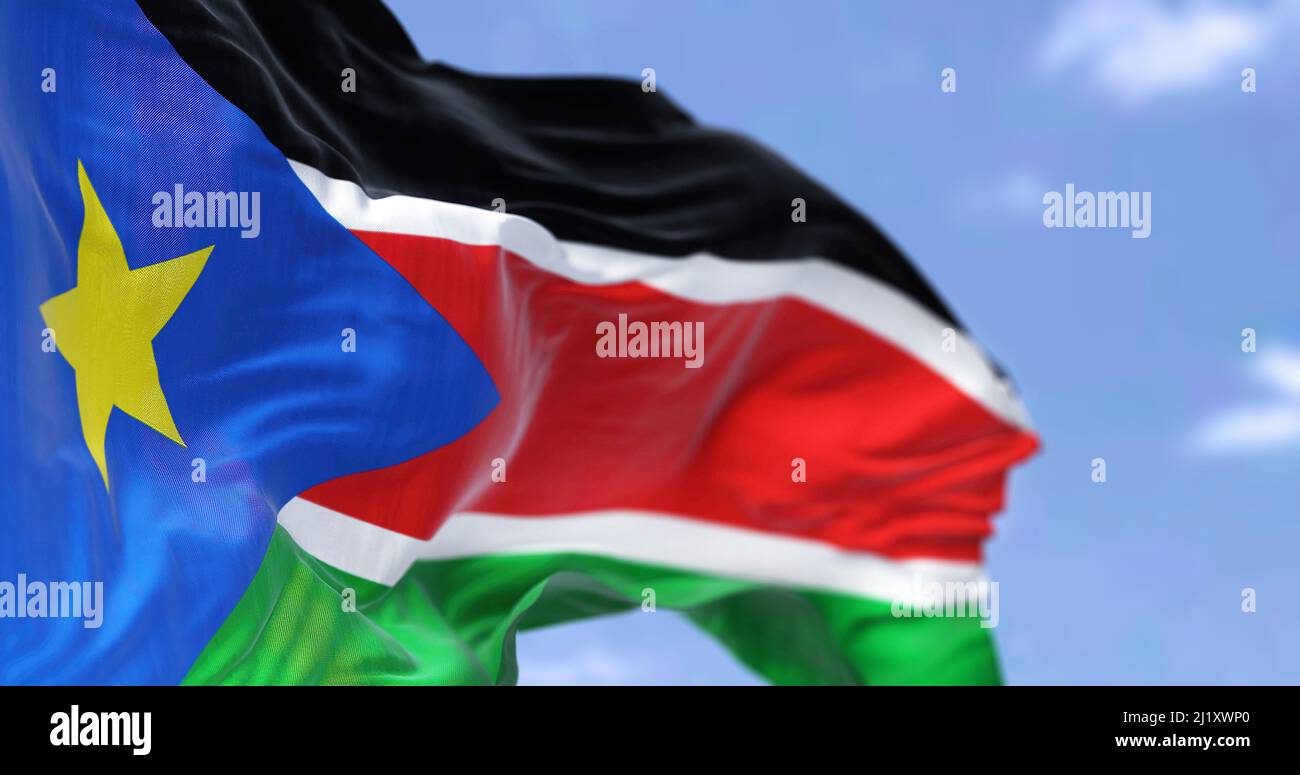 Detail of the national flag of South Sudan waving in the wind on a clear day. South Sudan is a landlocked country in central Africa. Selective focus. Stock Photo