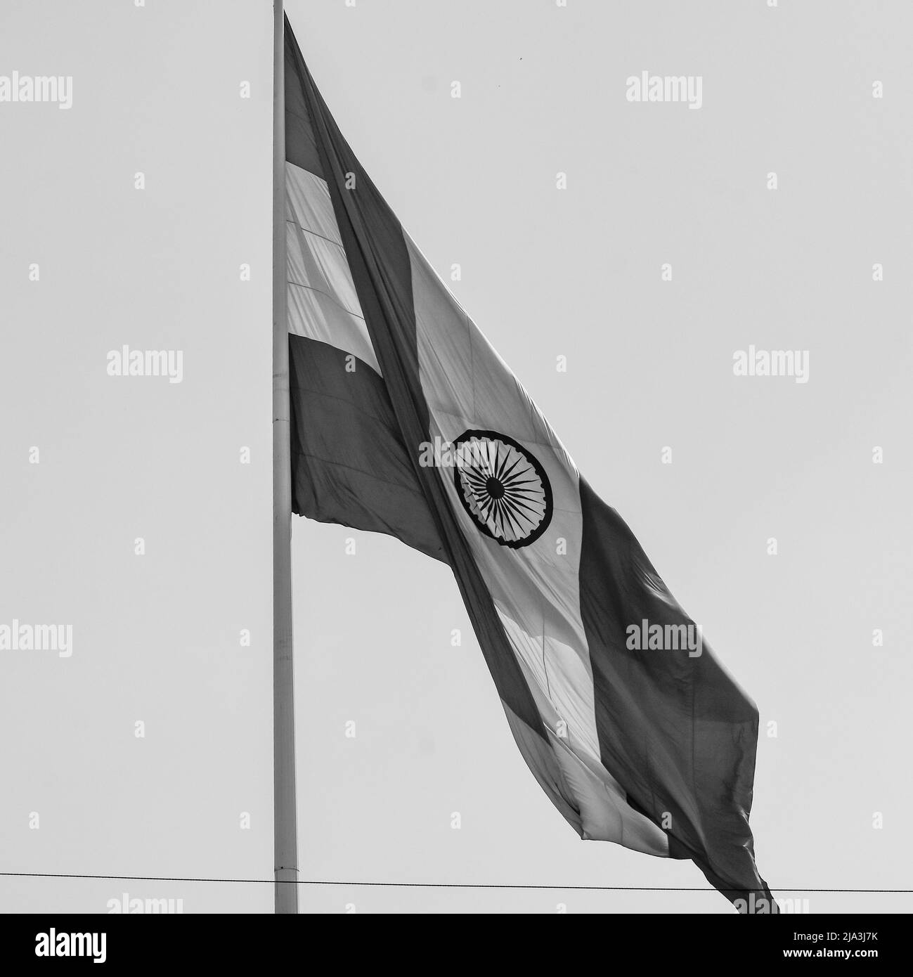 India flag flying at Connaught Place with pride in blue sky, India flag fluttering, Indian Flag on Independence Day and Republic Day of India, waving Stock Photo