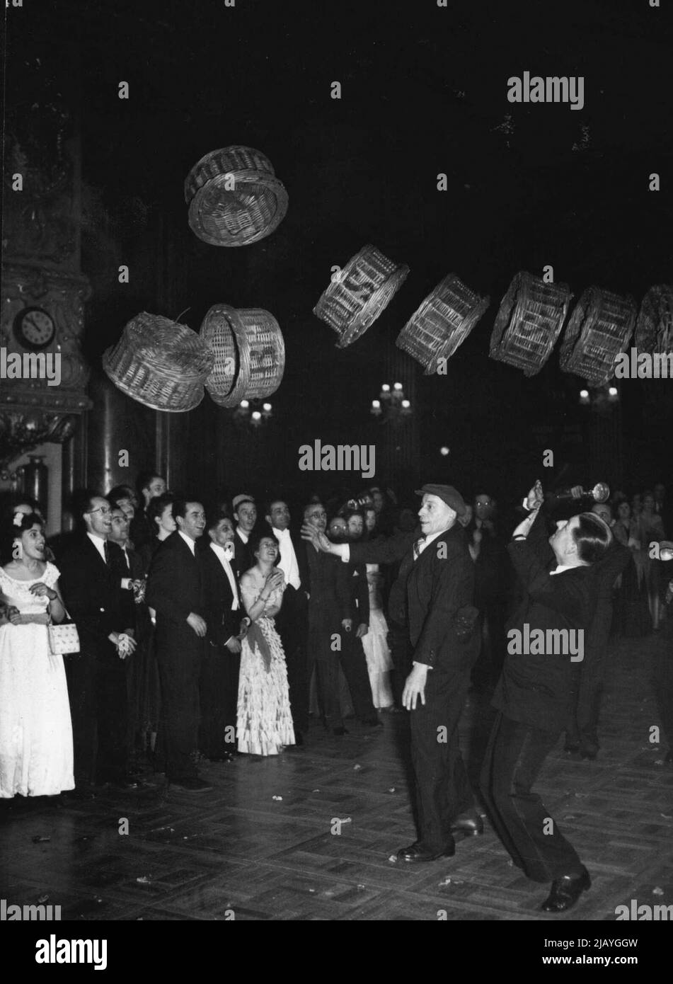 Basket Race At Ball -- Ronald Shiner, star of the 'Worms Eye View' show (left) had to duck quickly after starting the Covent Garden Porters basket race at the Liberal Party's annual ball held in the Lyceum Theatre, Drury Lane (London). February 18, 1949. Stock Photo