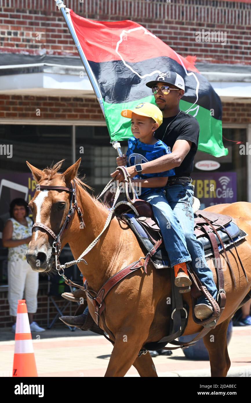 African American cowboys parade on horseback through Zebulon, NC, as part of a weekend long Juneteenth celebration of emancipation from slavery. Stock Photo