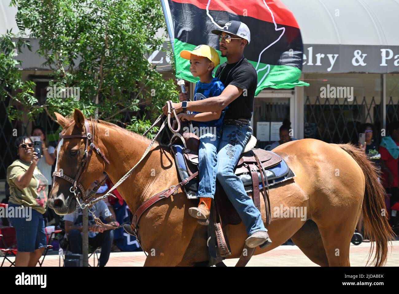 African American cowboys parade on horseback through Zebulon, NC, as part of a weekend long Juneteenth celebration of emancipation from slavery. Stock Photo