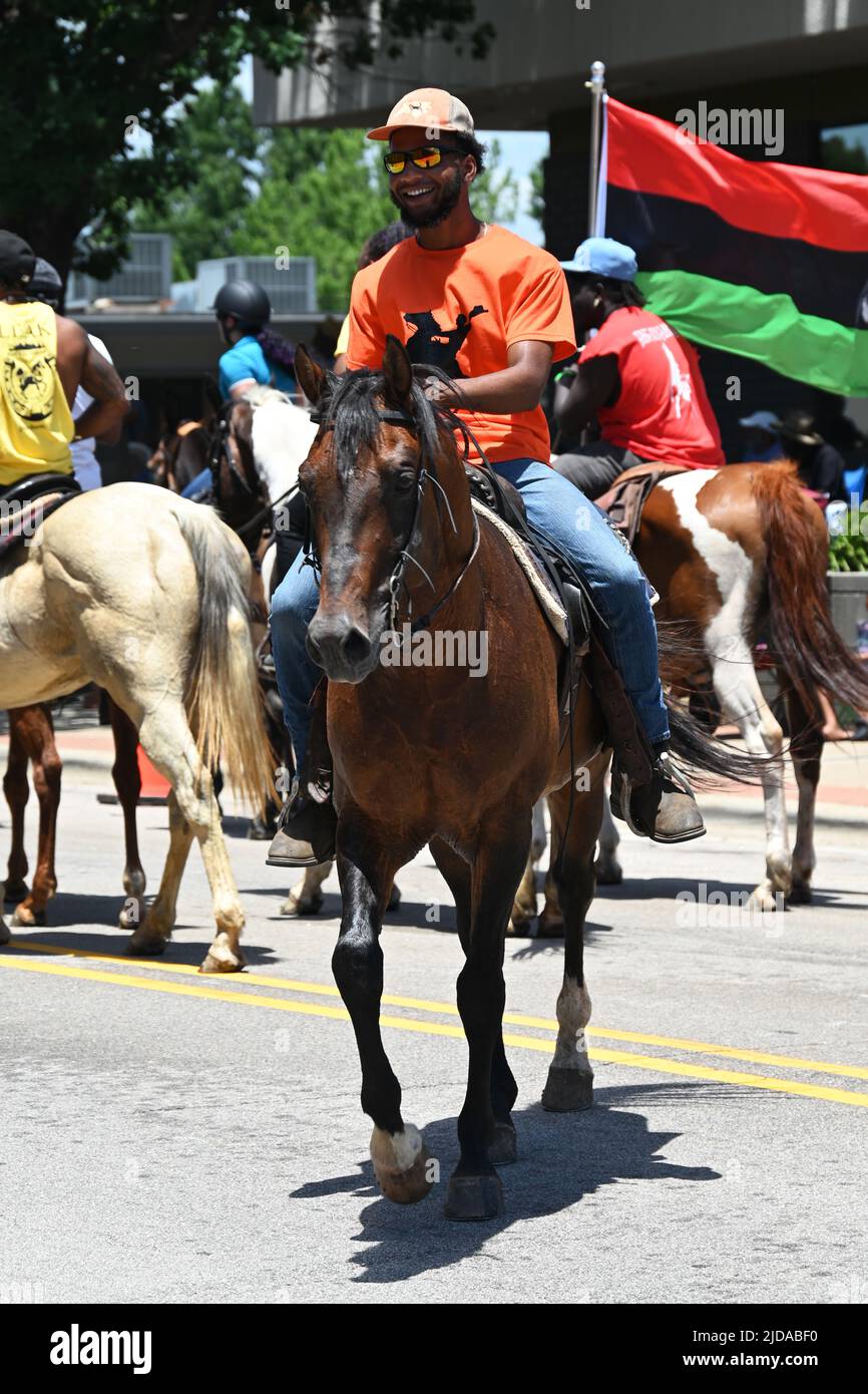 African American cowboys parade on horseback through Zebulon, NC, as part of a weekend long Juneteenth celebration of emancipation from slavery. Stock Photo