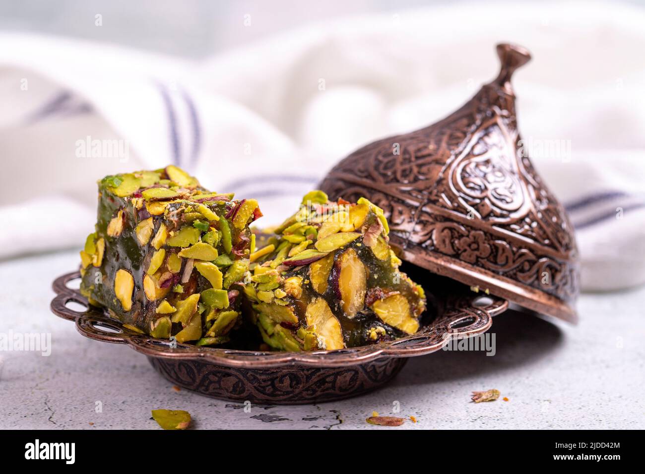 Turkish Delight with Pistachio on a stone background. Traditional Turkish delicacies. Turkish Delight with Apple Flavored Pistachio. close up Stock Photo