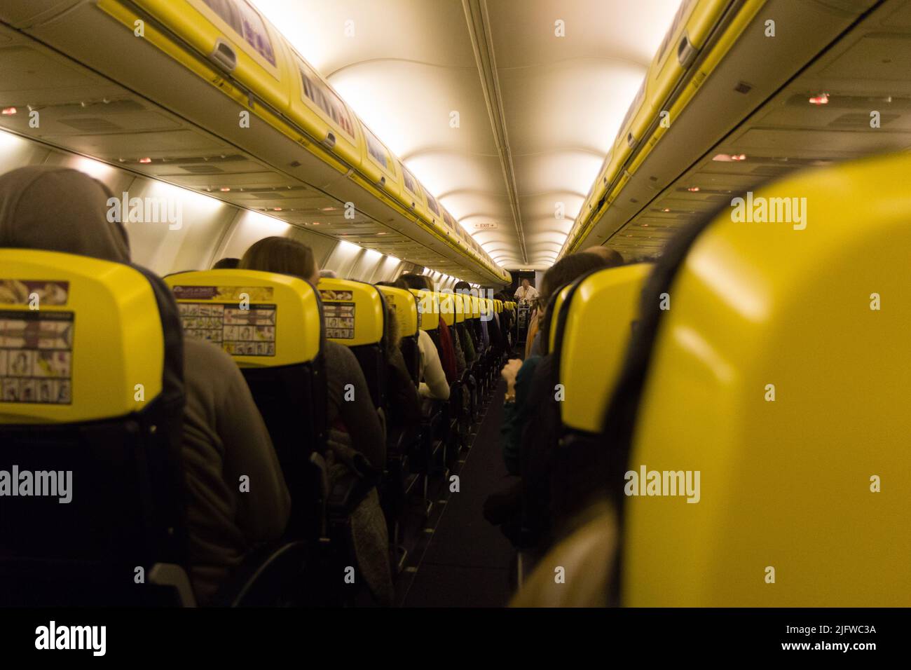 The aisle and the interior of a boarded plane. The aircraft is a ...