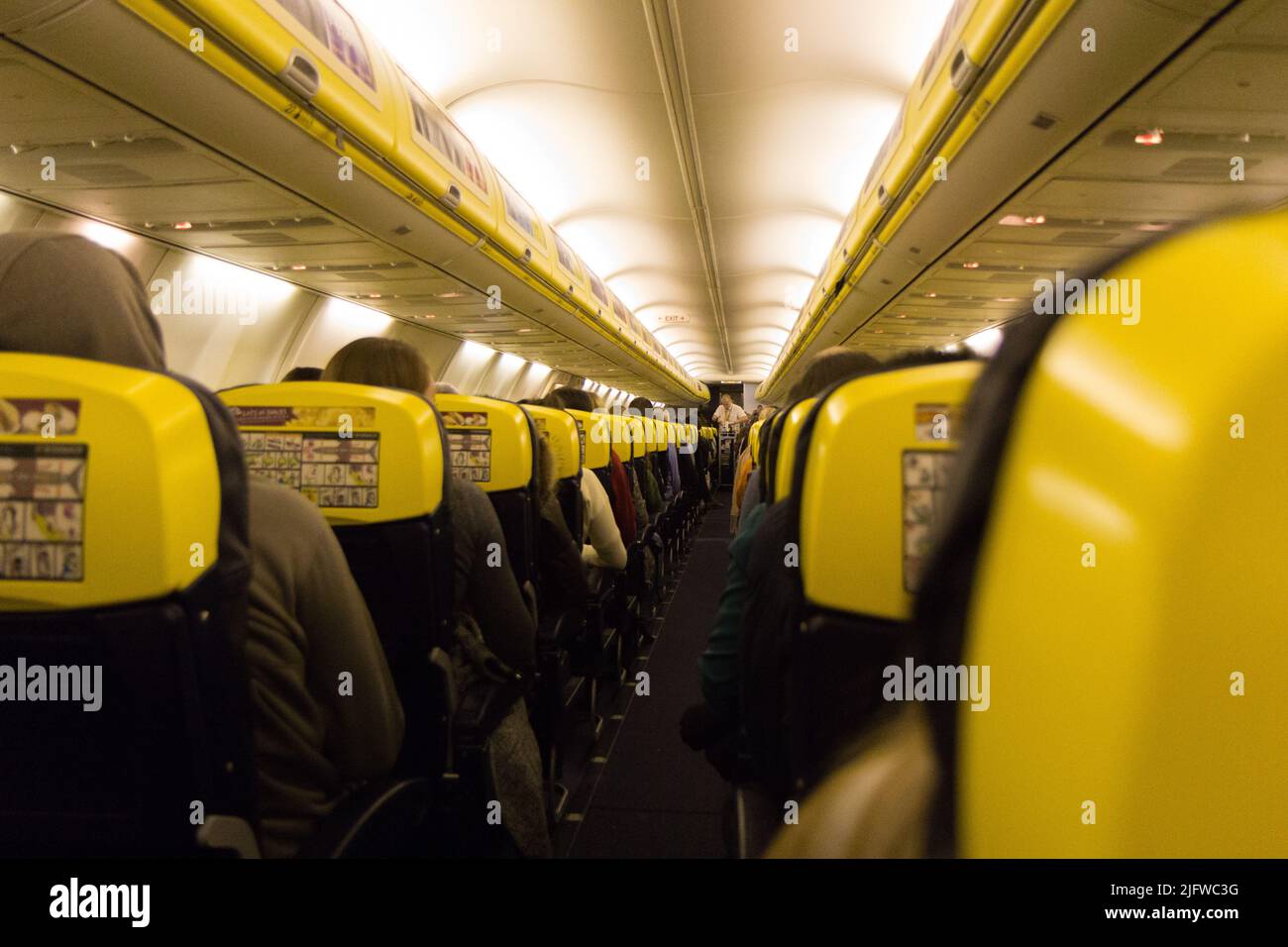 The aisle and the interior of a boarded plane. The aircraft is a ...