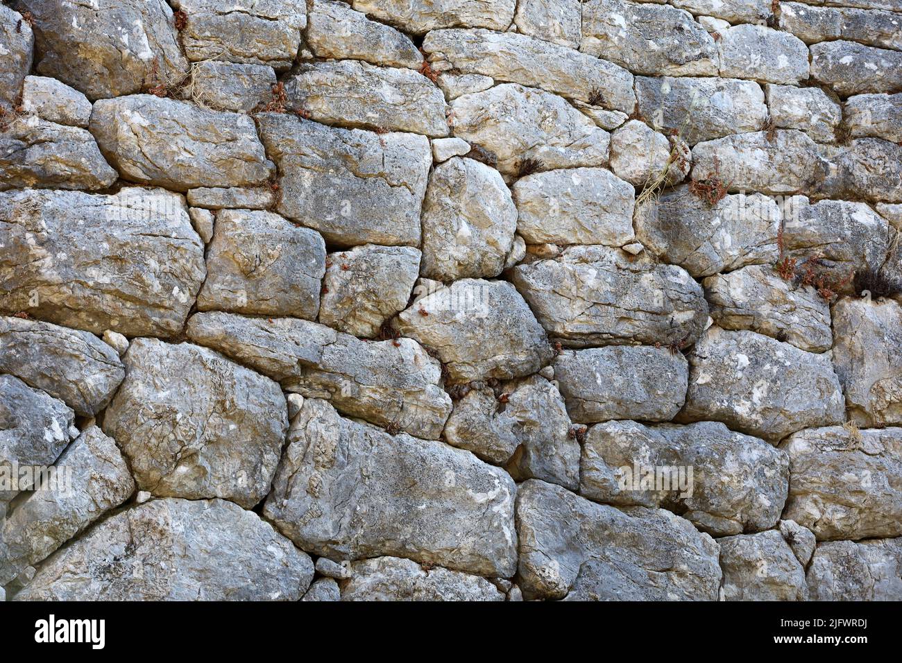 Polygonal masonry of stone wall of ancient Amos town in Turkey founded by the Dorians in the VII century BC Stock Photo