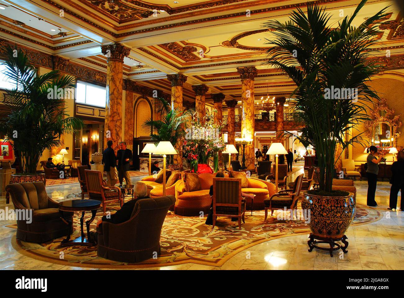 People enjoy relaxing in he lobby of the historic Fairmont Hotel, a grand luxury hotel and hospitality in San Francisco Stock Photo